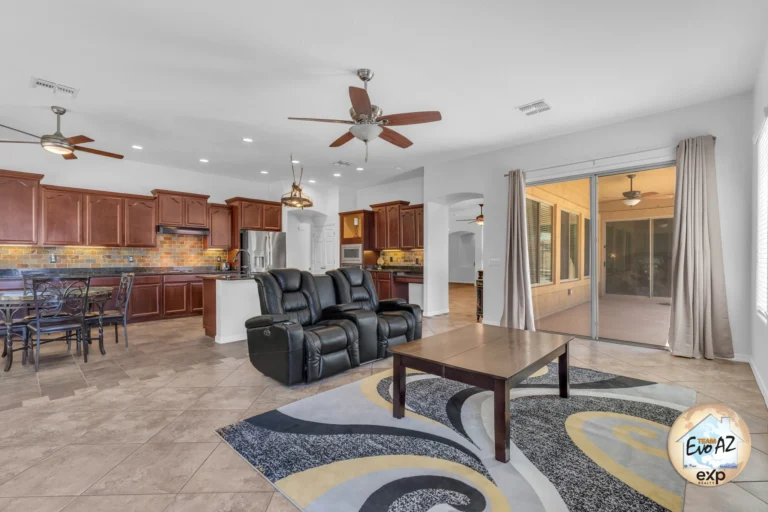 Open living room with tile flooring, ceiling fan, and seating area