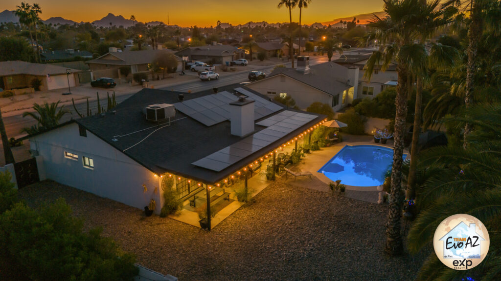 Aerial night view of a single level Scottsdale home with pool and landscaped yard