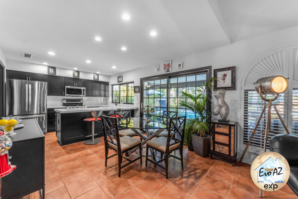 Open kitchen and dining area with peninsula seating and modern lighting