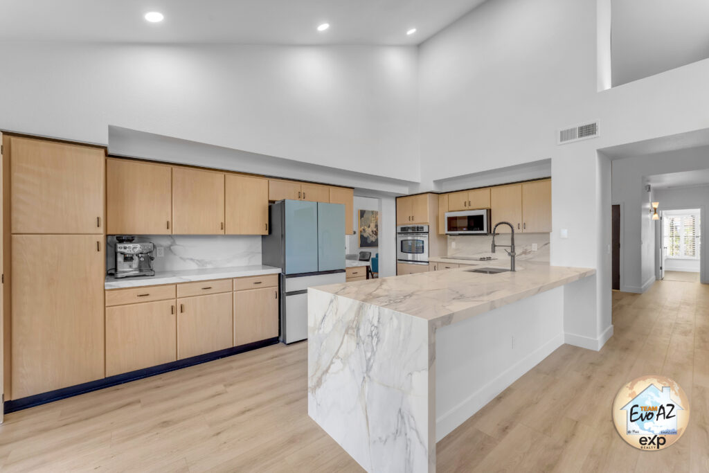 Remodeled kitchen with waterfall countertops and modern cabinetry