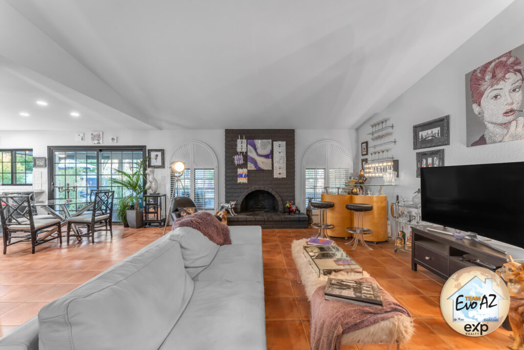 Spacious great room with fireplace, tile flooring, and vaulted ceilings