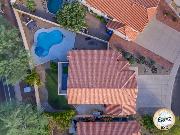Aerial view of a Phoenix foothills home showing a backyard pool and surrounding neighborhood
