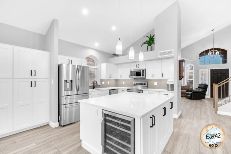 Open concept kitchen and living area with vaulted ceilings inside