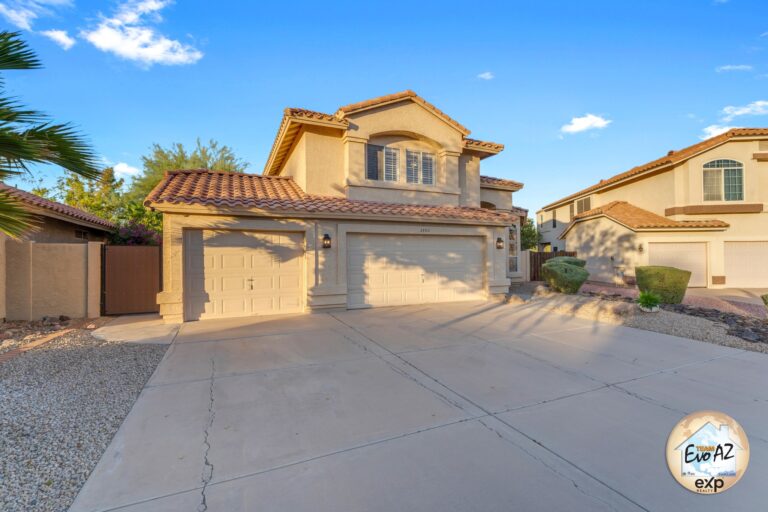 Front exterior of a single family home in Ahwatukee Arizona with driveway and desert landscaping
