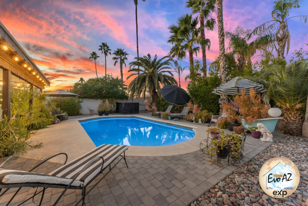 Private backyard with diving pool, palm trees, and sunset views at a Scottsdale home on Hearn Road