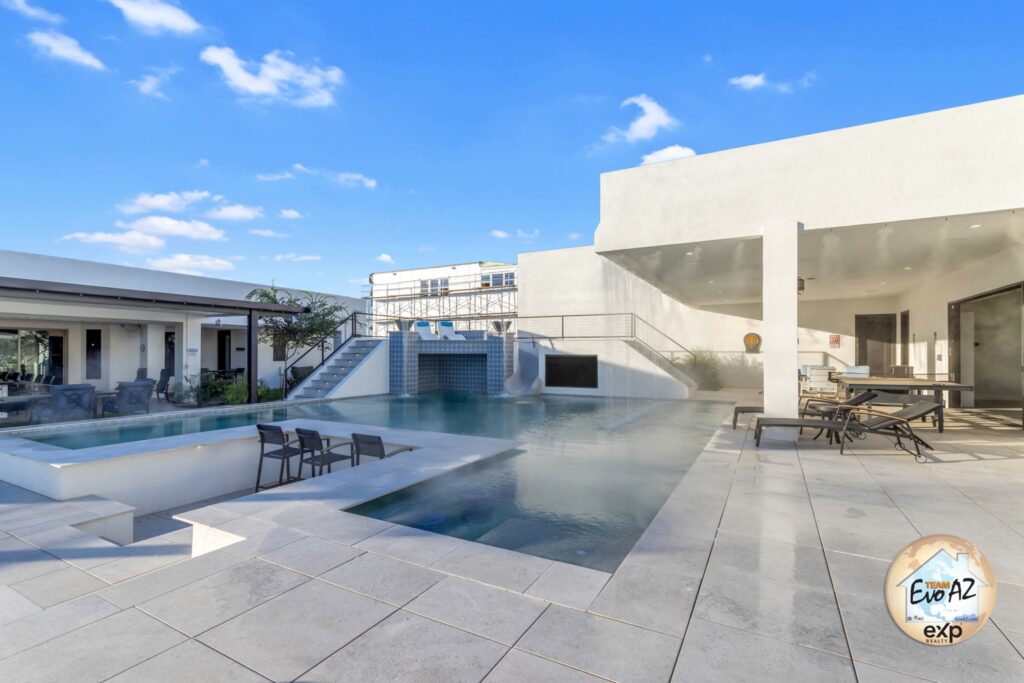 Extra-large swimming pool with swim-up bar and patios at a luxury custom home in Surprise AZ